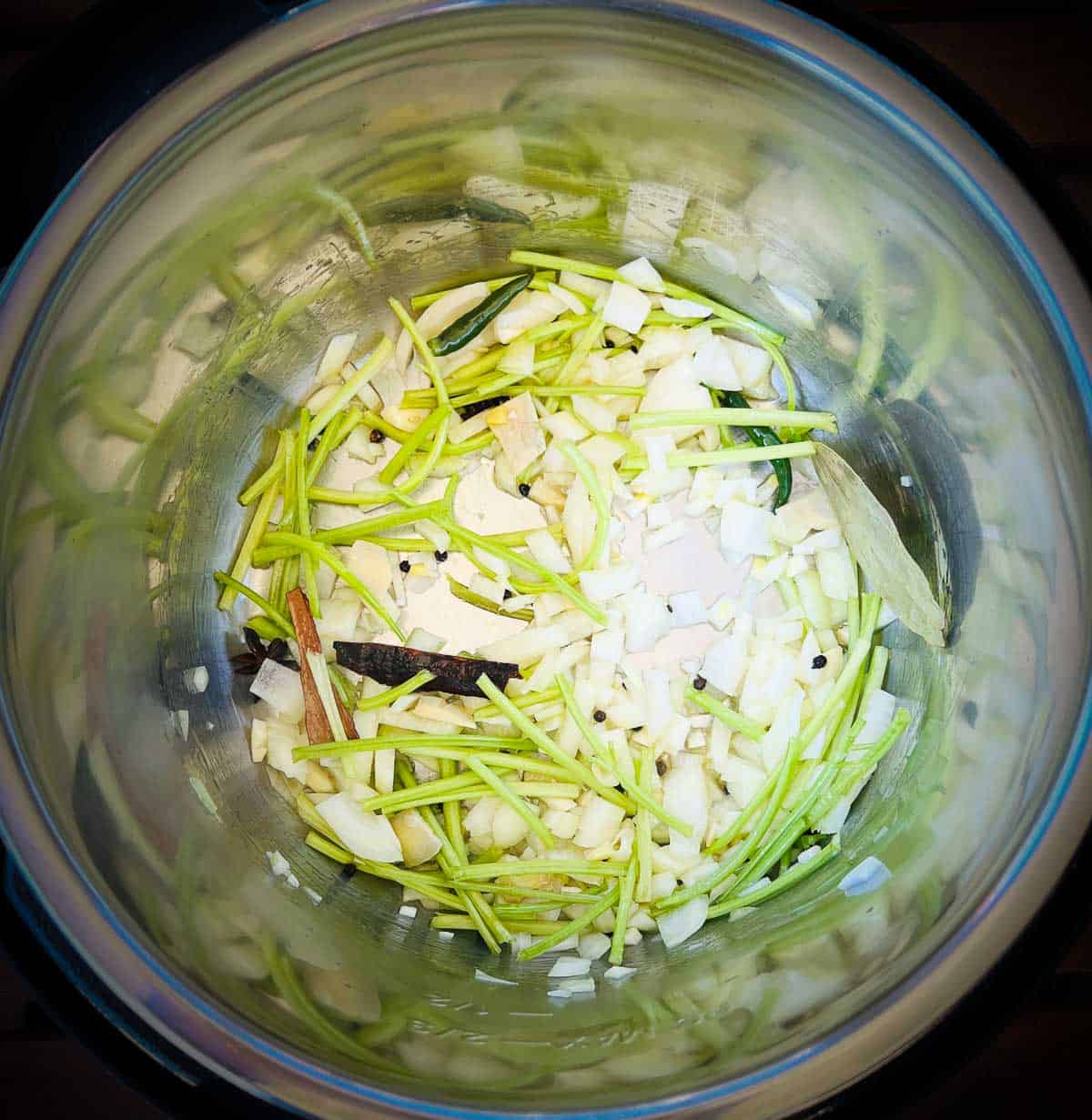 Saute spices, onions, and cilantro in the Instant Pot.