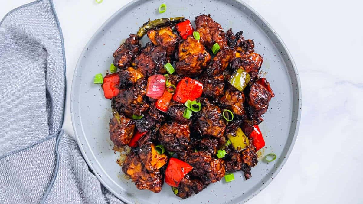 Chilli chicken on a grey plate.