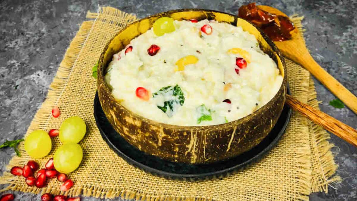 Curd rice served in a coconut bowl.