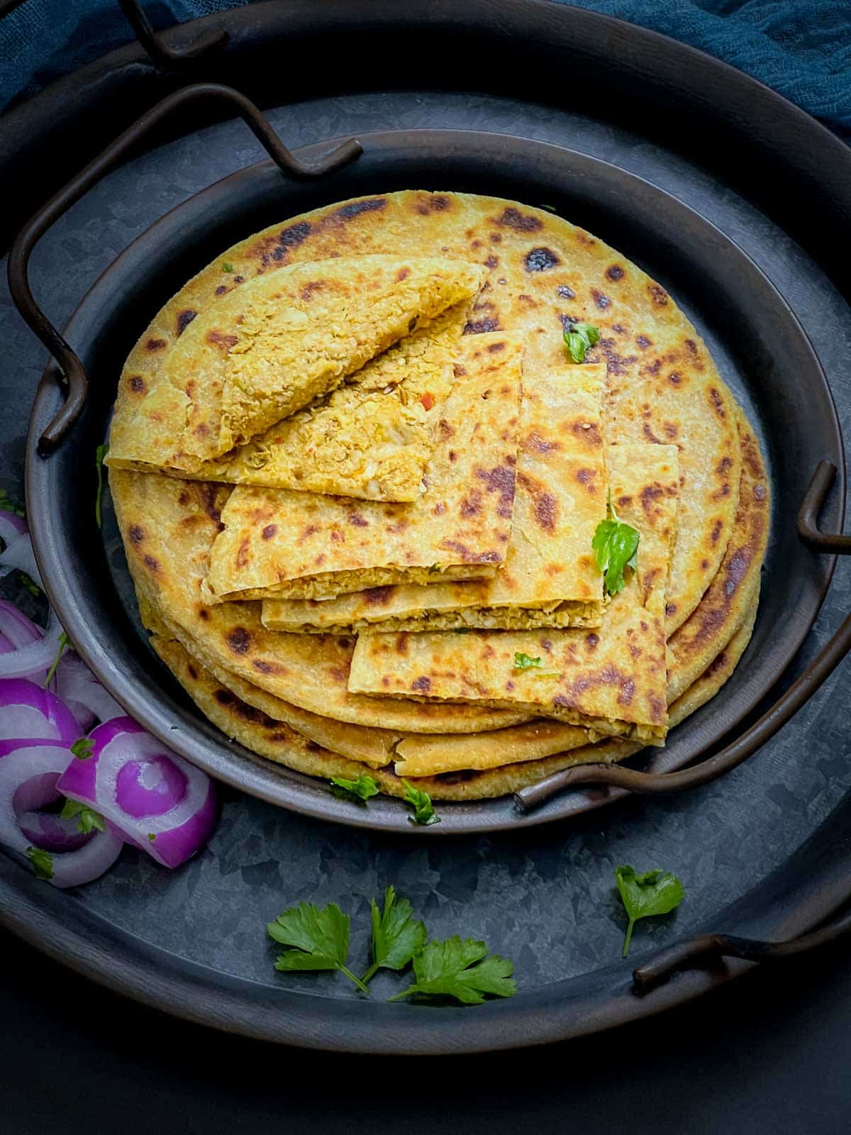 A piece of cut gobi paratha to show the filling inside.