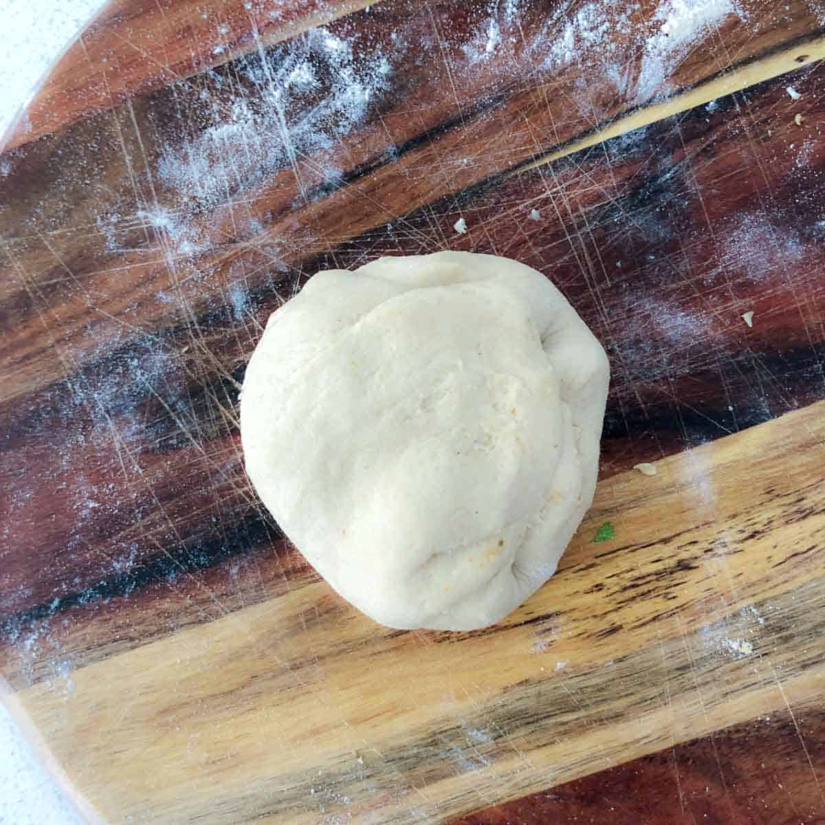 Step showing sealed dough with filling inside.