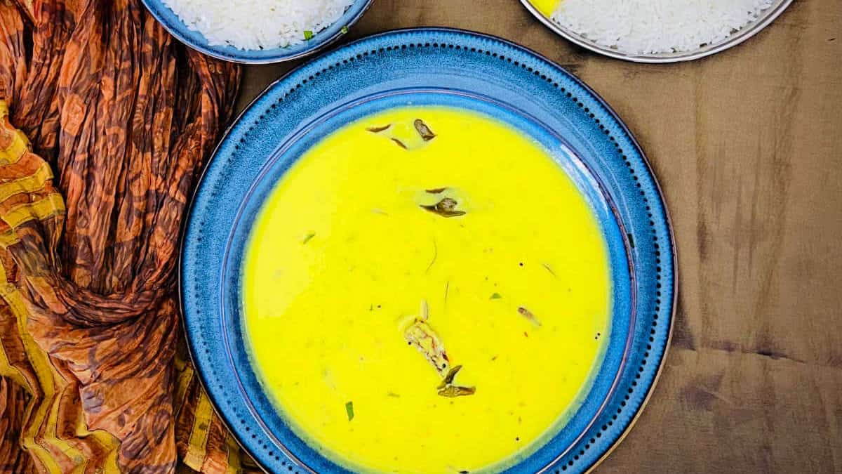 Gujarati kadhi served with rice in a blue bowl.
