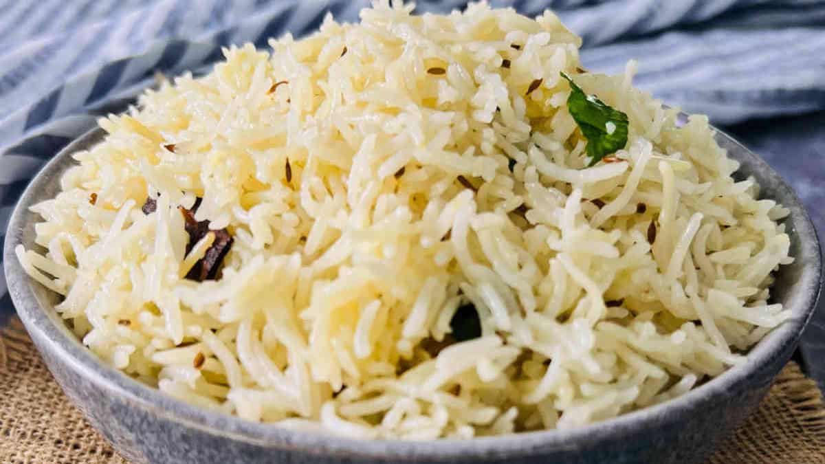 Jeera rice in a grey bowl.