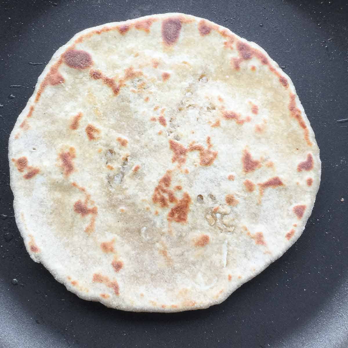 Flip and cook the mooli paratha on both sides.