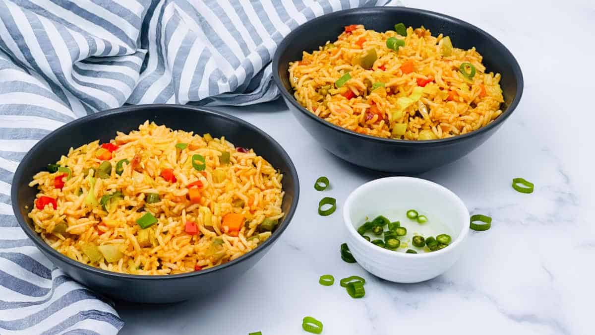 Veg fried rice in a black bowl.