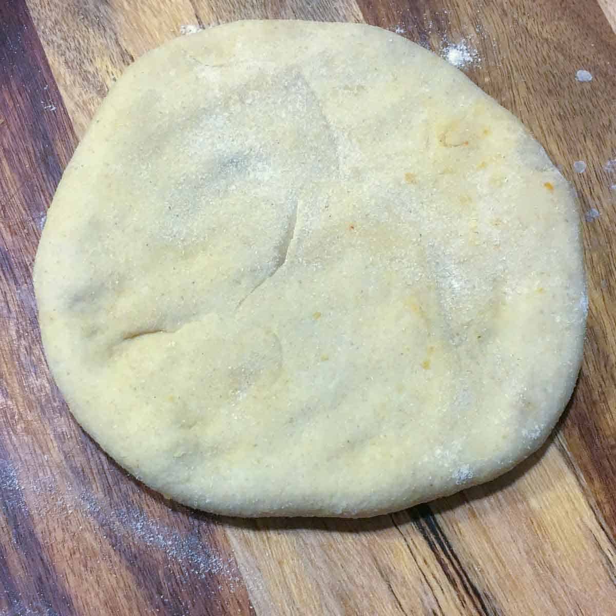 Step showing the sealed dough with potato filling inside.
