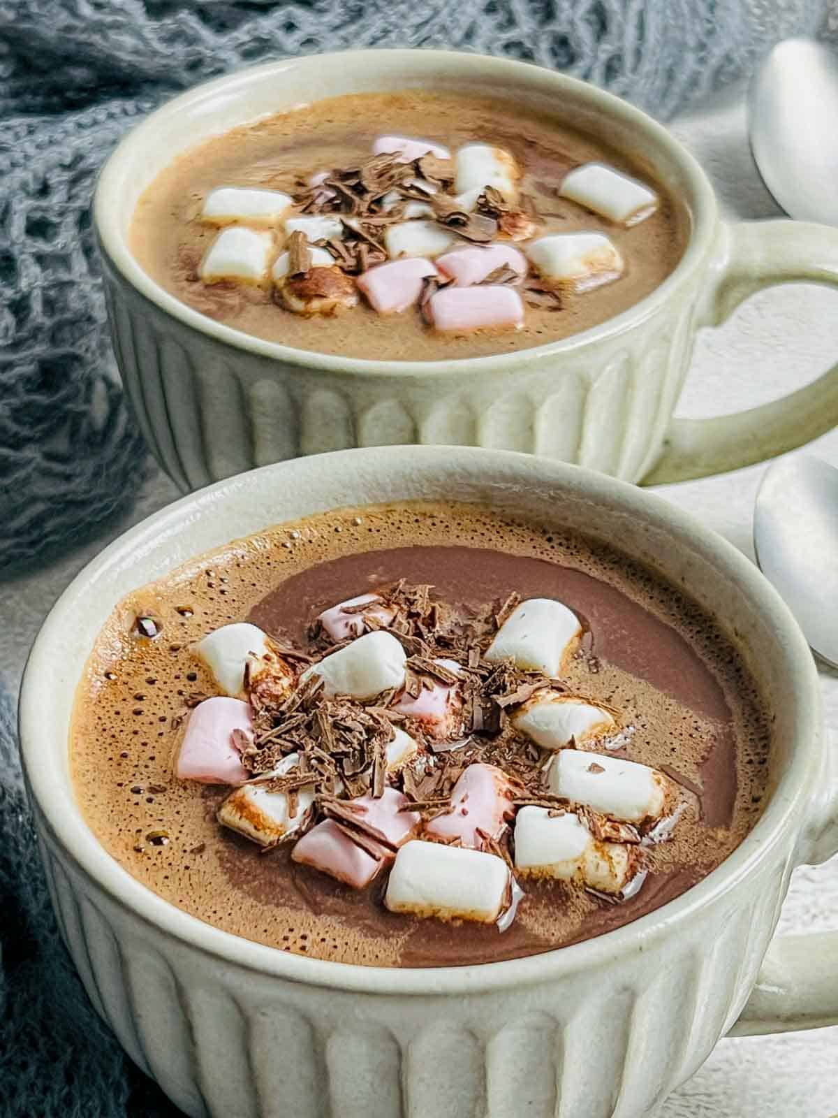 Cardamom hot chocolate in white mug.