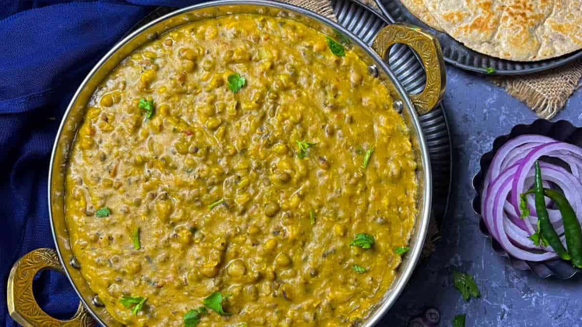 Green moong dal served in a steel kadhai.