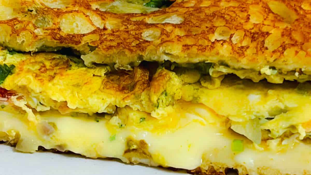 Cheese oozing out of bread omelet.