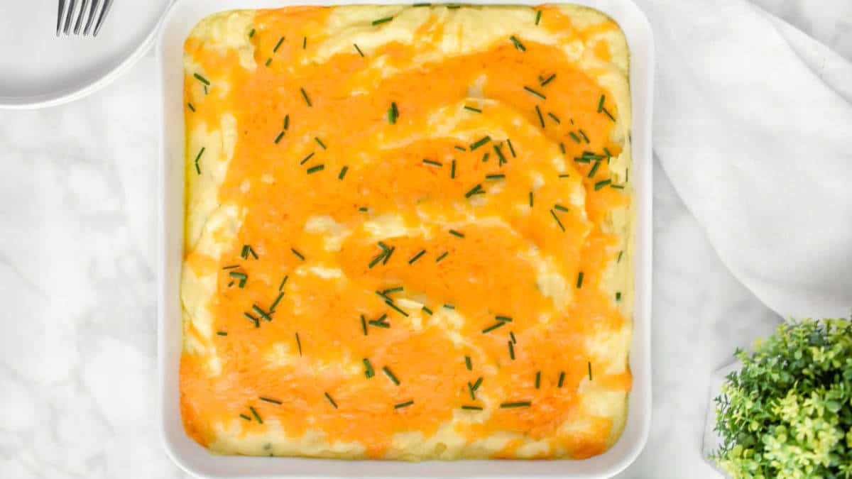 Baked mashed potatoes in a white dish.