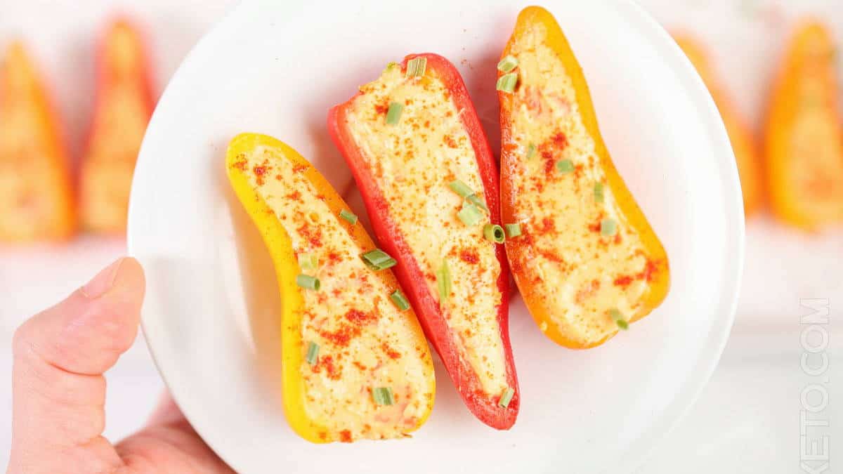 Cheese stuffed peppers on a white plate.
