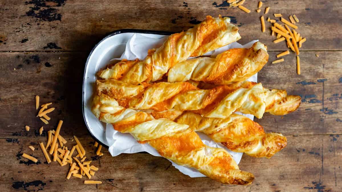 Garlic cheese twists on a wooden surface.