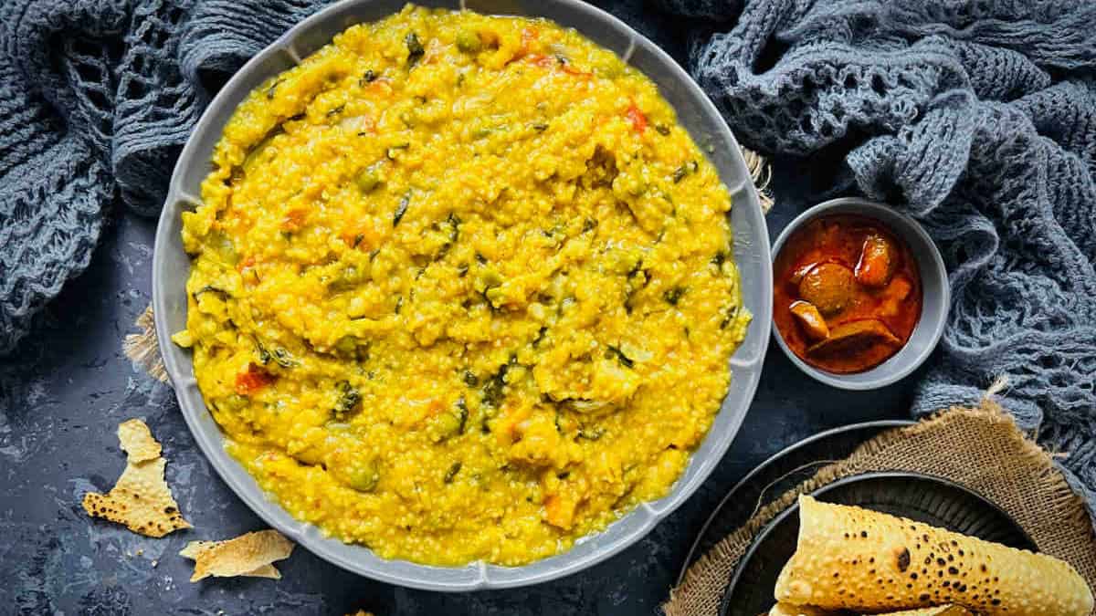 Millet khichdi served with pickle and papad.