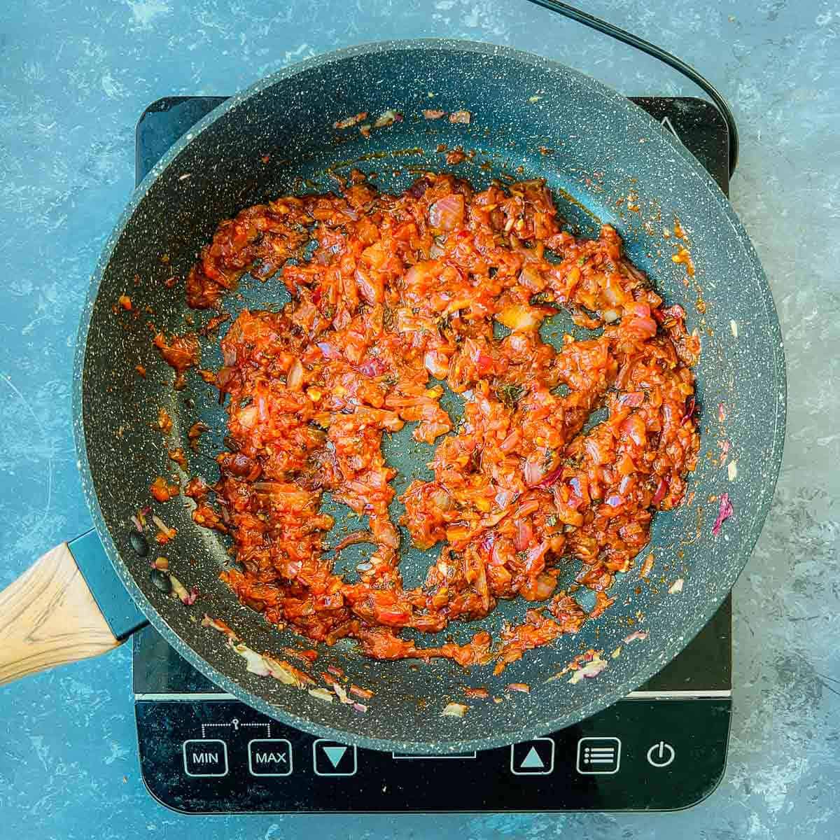 Tomato puree and spices cooked with onions.