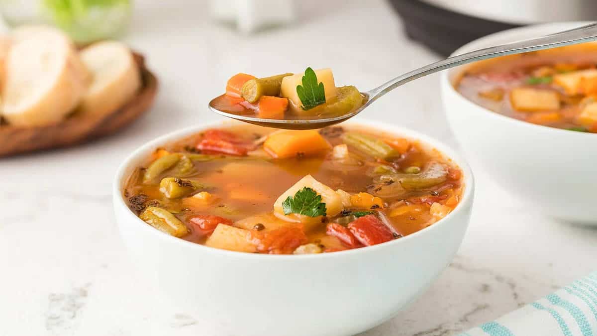 Vegetable soup in a white bowl.