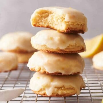 A stack of lemon cookies on a cooling rack.