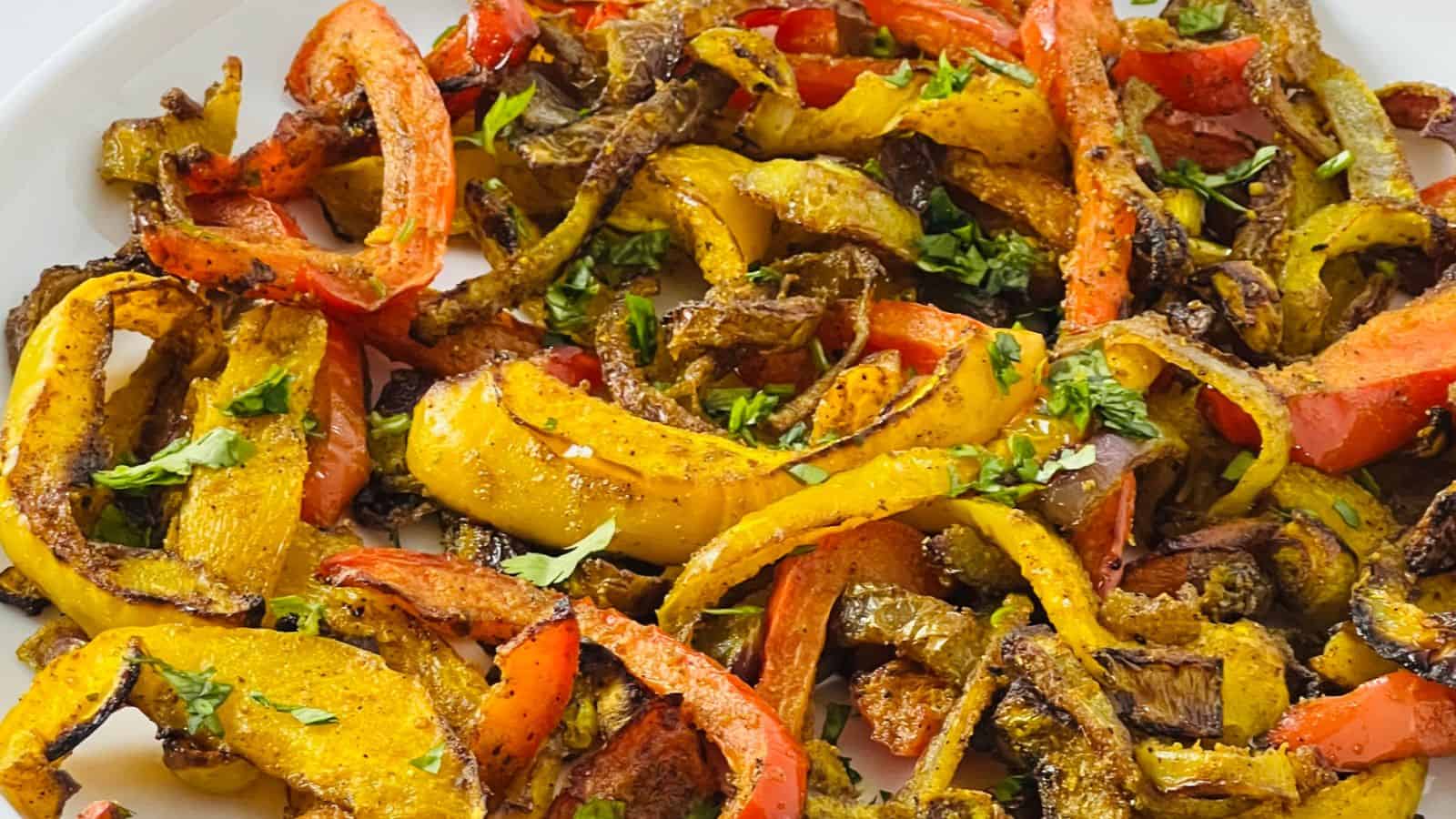 A plate of sautéed colorful bell peppers seasoned with herbs and spices.