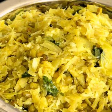 A bowl of indian Cabbage Palya garnished with herbs.