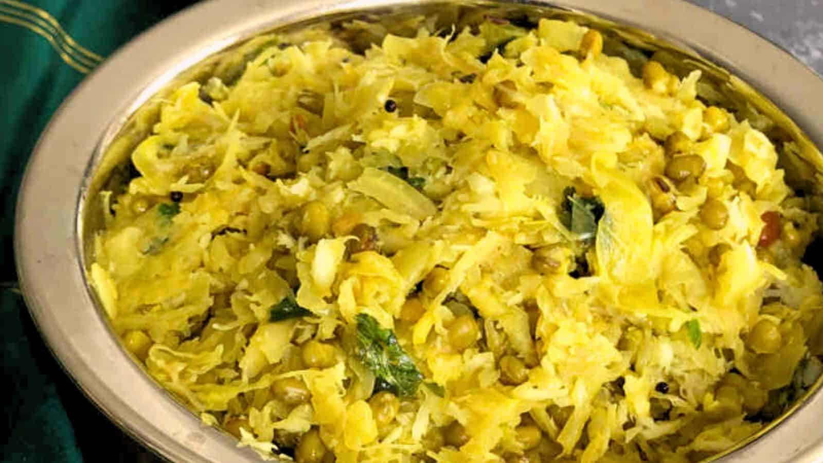 A bowl of indian Cabbage Palya garnished with herbs.