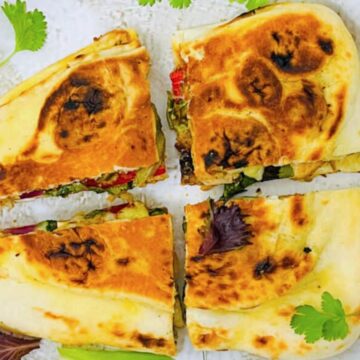 A platter of freshly made, golden-brown Naan served.