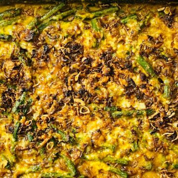 Baked casserole with green beans and crispy fried onions on top.