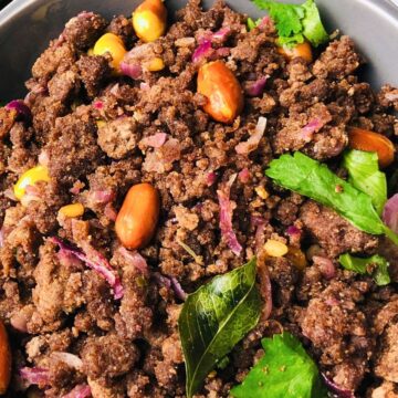 A bowl of ragi ugma filling with vegetables and beans.