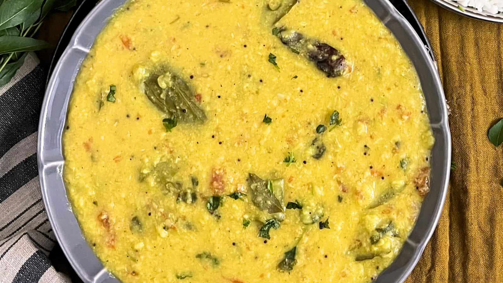 A bowl of Ridge Gourd Moong Dal with chopped herbs.