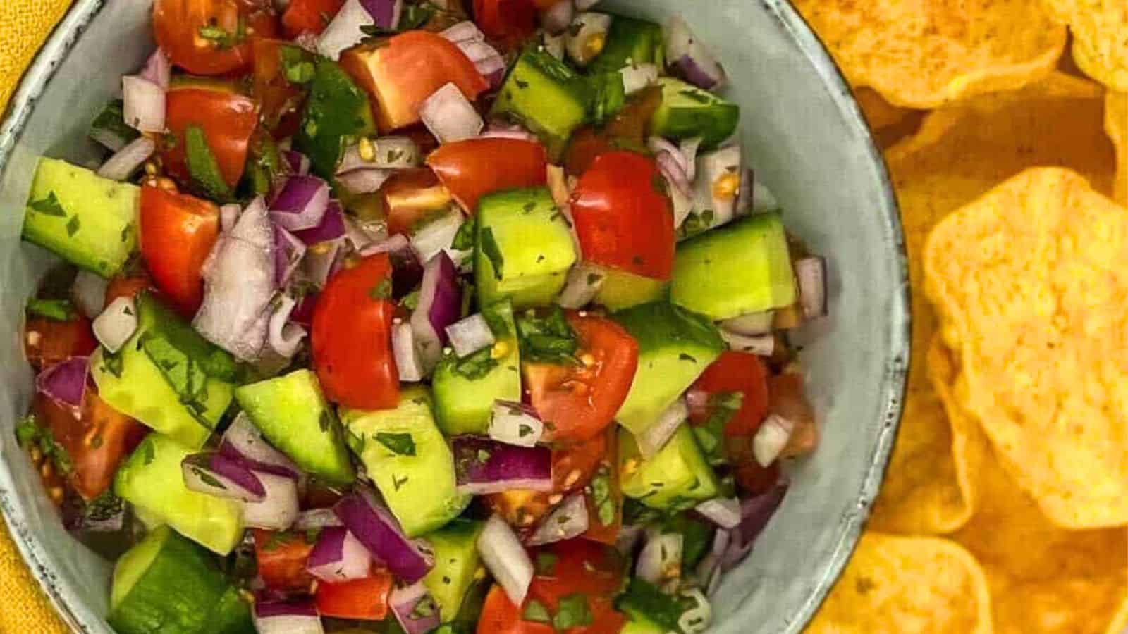 Chunks of tomato, cucumber, and onion in a bowl.