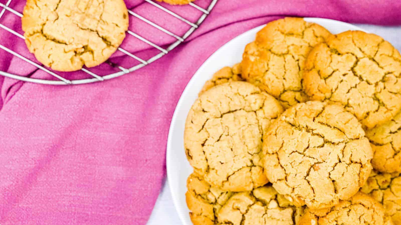 A stack of peanut butter cookies on a cooling rack.