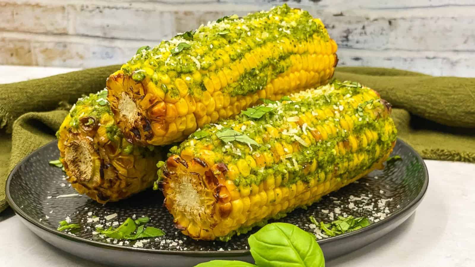 Pesto corn on the cob on a serving plate.