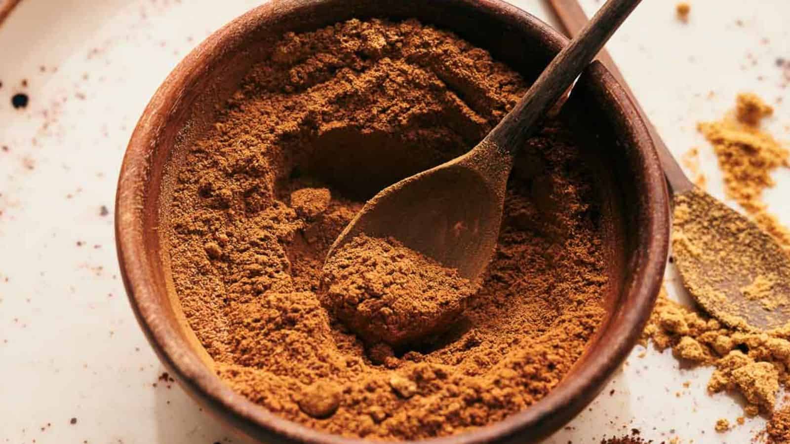 Pumpkin pie spice in a bowl with a spoon.