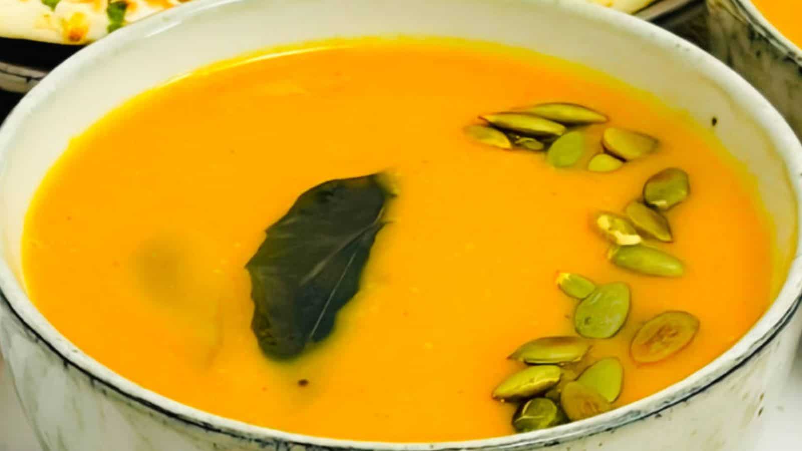 Butternut squash soup served in brown bowls.
