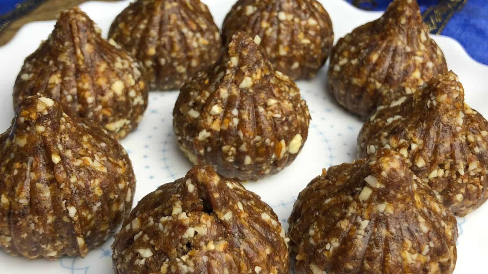 A plate of homemade fig and nut confections shaped like small domes, presented on a blue and white patterned plate.