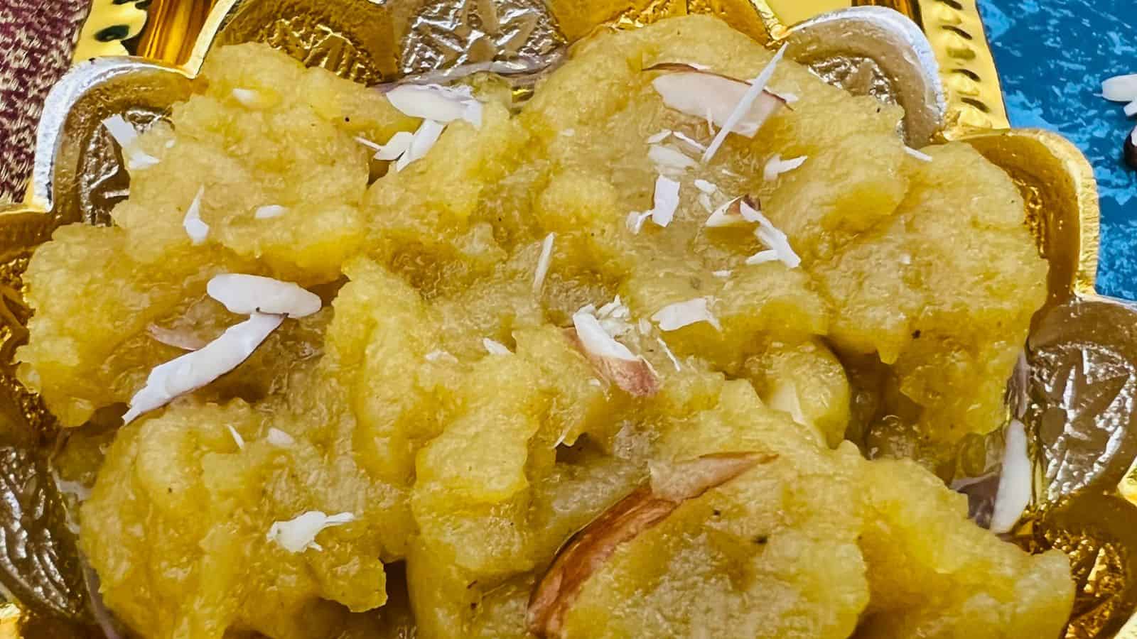 Moong dal halwa bowls on a blue surface.