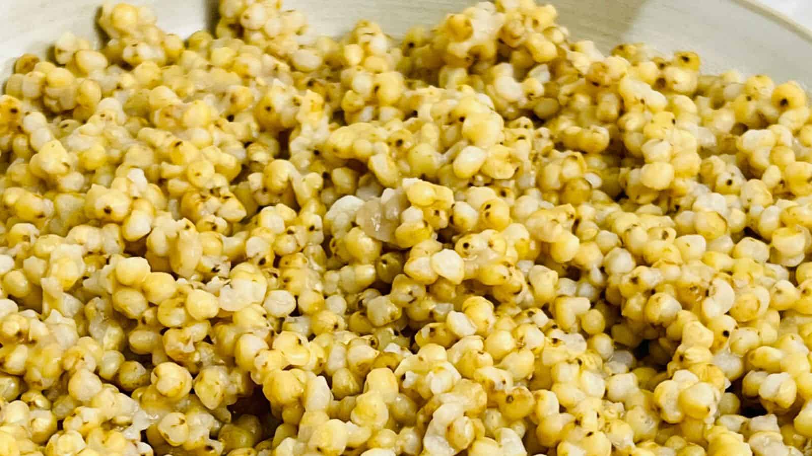 A close-up view of a bowl filled with freshly popped yellow popcorn.