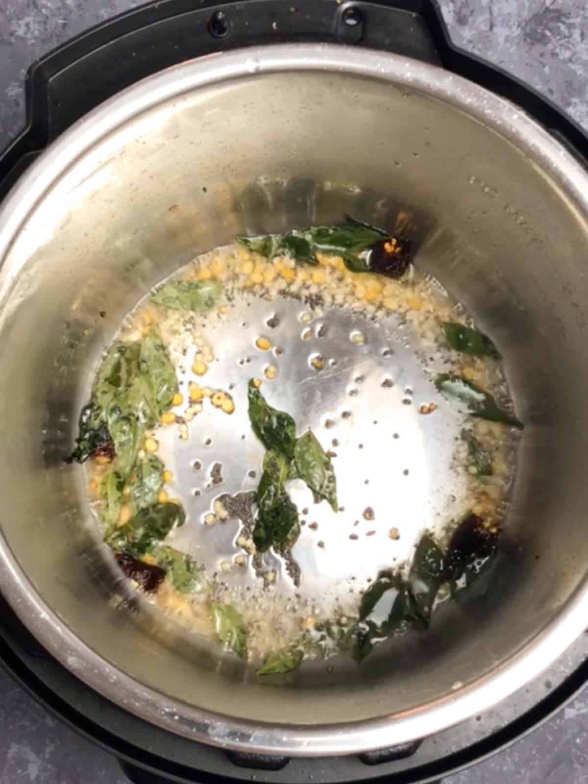 Mustard and Cumin Seeds with chilis and curry leaves.